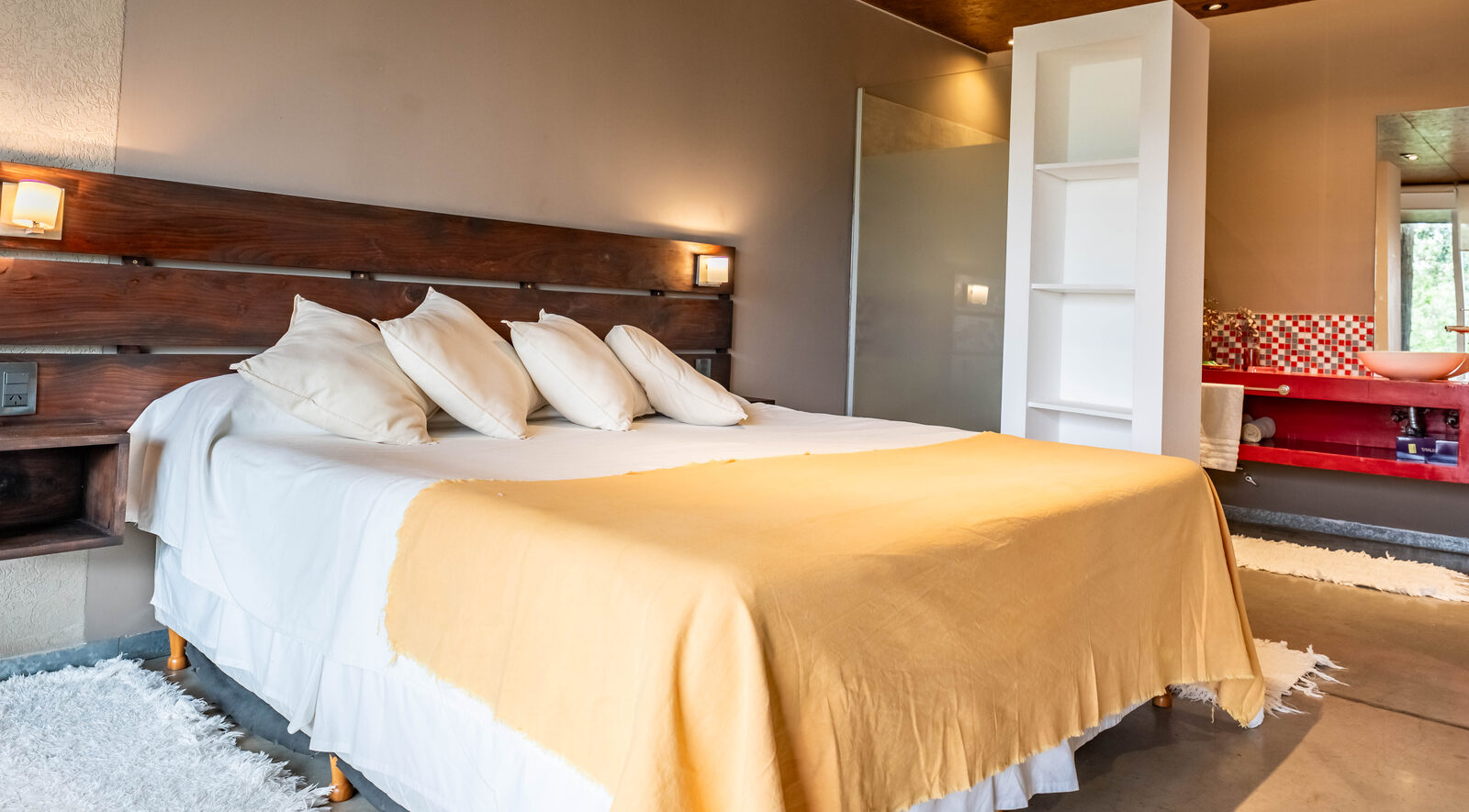 The studio bed against the floor-to-ceiling window onto the lake