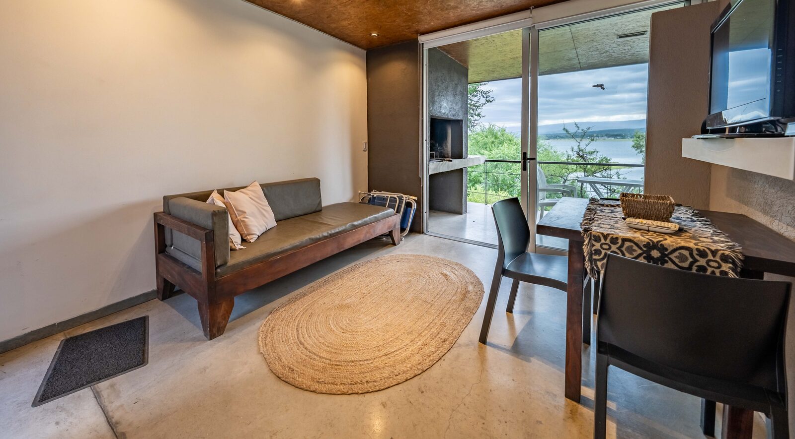 Sitting area of the studio with the veranda and Lake Los Molinos beyond